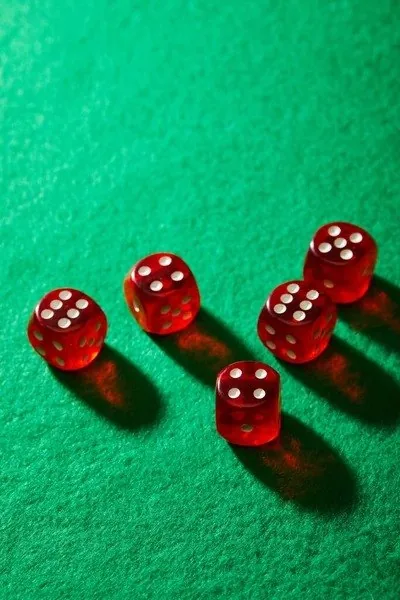 Five red dice on green felt